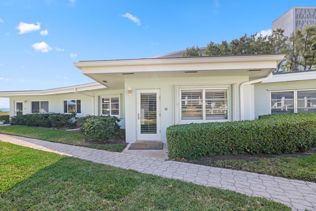 entrance to property with a yard