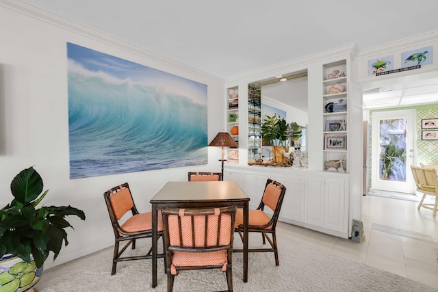 dining room with light tile patterned floors, built in shelves, and crown molding