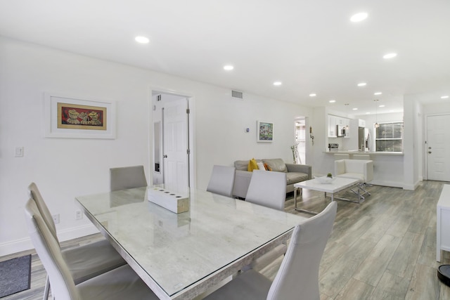 dining room with light hardwood / wood-style flooring