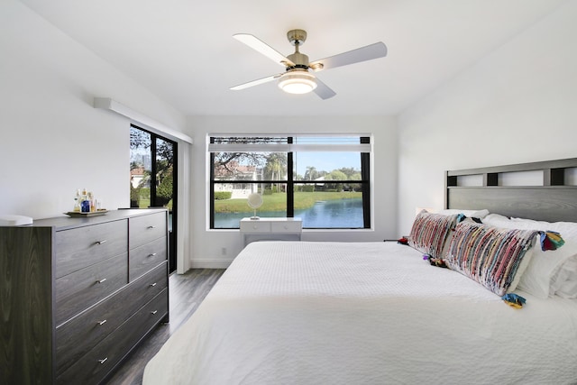 bedroom featuring ceiling fan and dark wood-type flooring