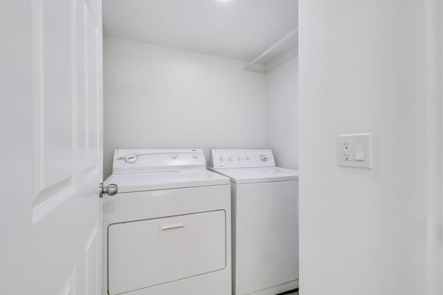 clothes washing area with separate washer and dryer