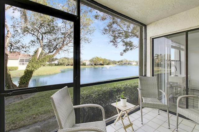 sunroom / solarium featuring a water view