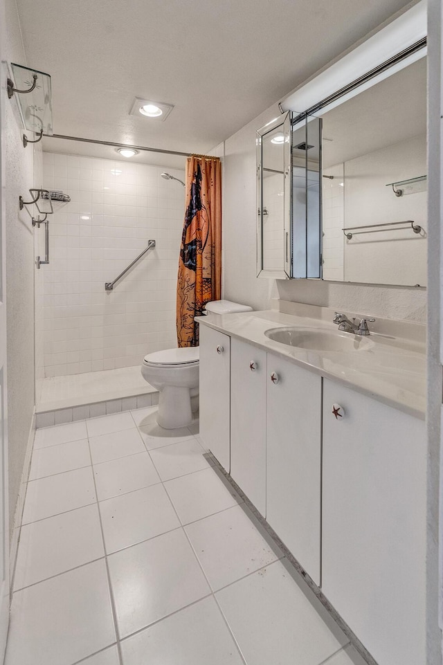 bathroom with curtained shower, tile patterned flooring, vanity, and toilet