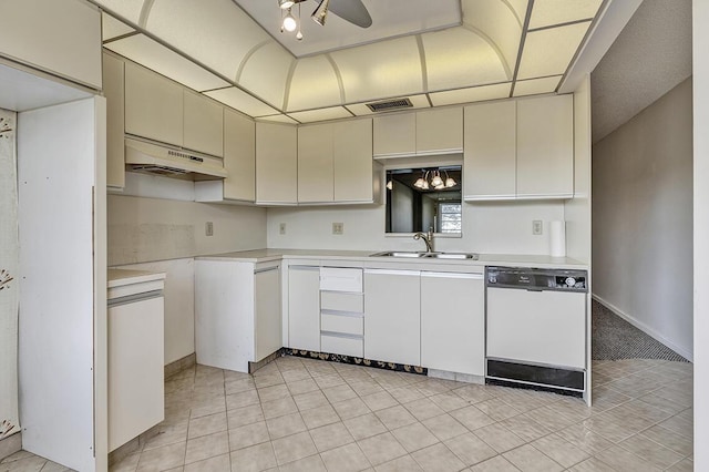 kitchen with white dishwasher, sink, ceiling fan, light tile patterned flooring, and white cabinetry