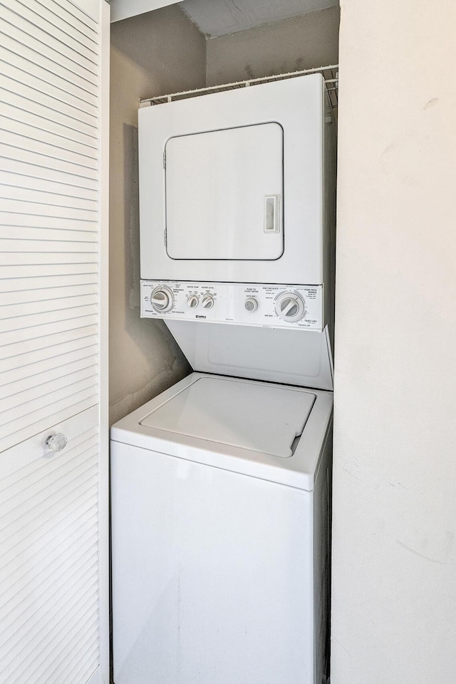 laundry area with stacked washer and dryer