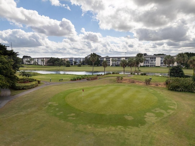 view of property's community featuring a yard and a water view