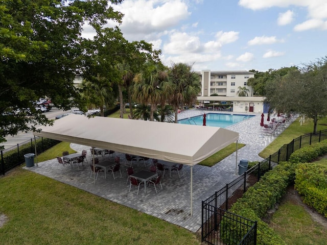 view of swimming pool with a patio area and a lawn