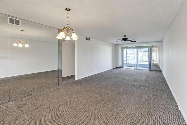 carpeted spare room featuring a textured ceiling and ceiling fan with notable chandelier