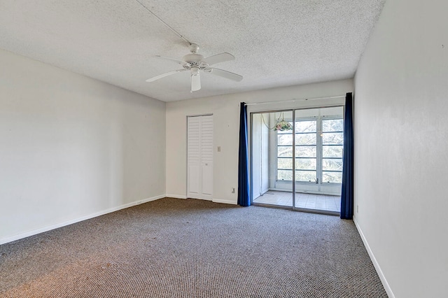 spare room with carpet flooring, ceiling fan, and a textured ceiling