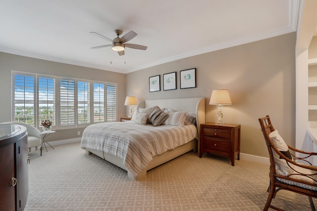 carpeted bedroom with ceiling fan and ornamental molding