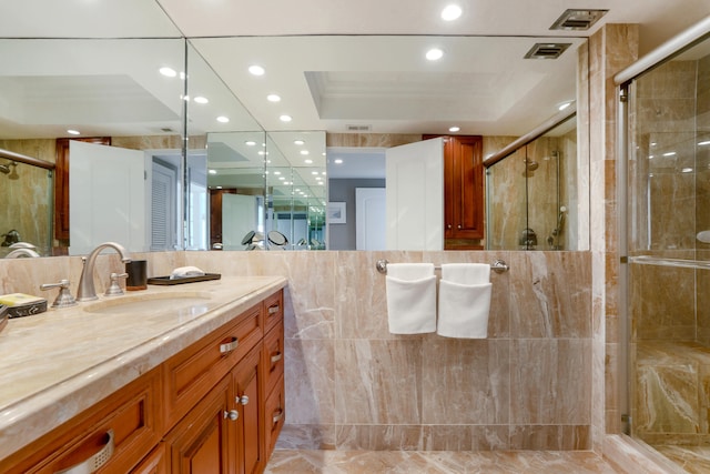 bathroom featuring vanity, a raised ceiling, and walk in shower