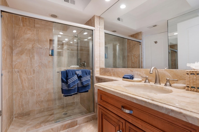 bathroom featuring tile walls, decorative backsplash, vanity, and an enclosed shower