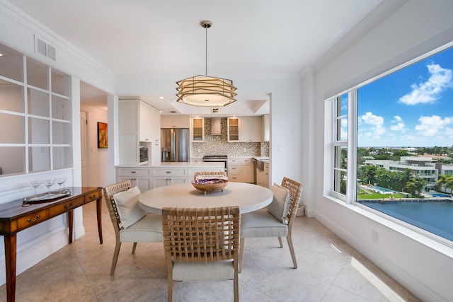 tiled dining room with crown molding