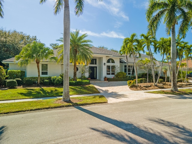 mediterranean / spanish house with a front yard