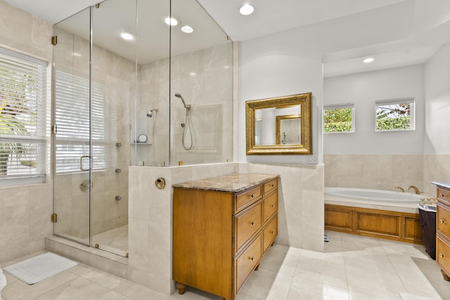 bathroom featuring tile patterned floors, vanity, and independent shower and bath