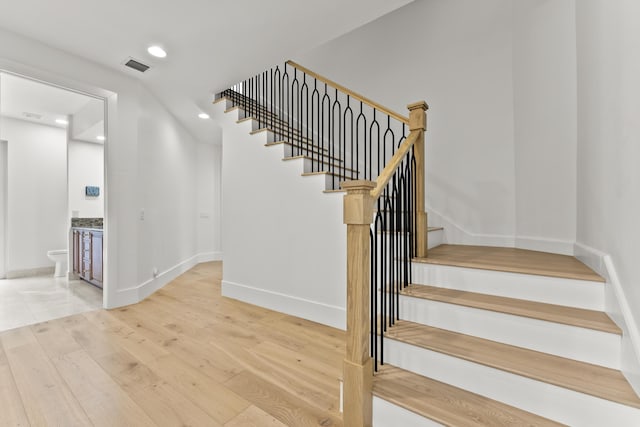 stairway featuring hardwood / wood-style floors