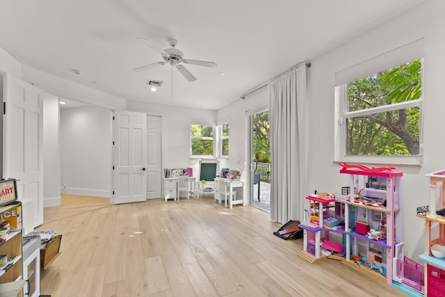 rec room featuring ceiling fan and light wood-type flooring