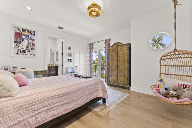 bedroom with access to exterior and light hardwood / wood-style flooring