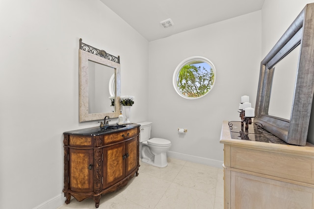 bathroom with vanity, tile patterned flooring, and toilet