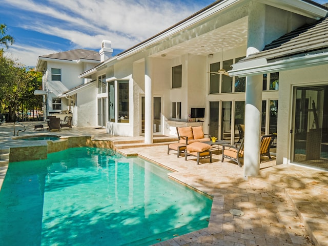 view of swimming pool featuring an outdoor hangout area, a patio, and an in ground hot tub