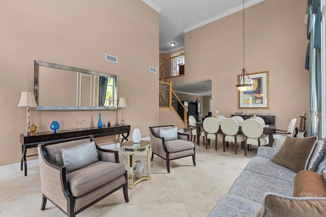 living room featuring crown molding and a high ceiling