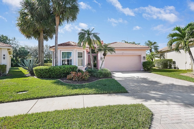 mediterranean / spanish-style home featuring a garage and a front yard