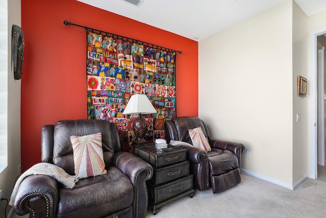 living area featuring light carpet