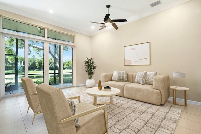 living room with ceiling fan, light tile patterned floors, and crown molding