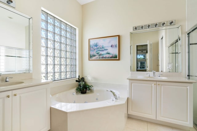 full bathroom with a stall shower, two vanities, a sink, and a whirlpool tub