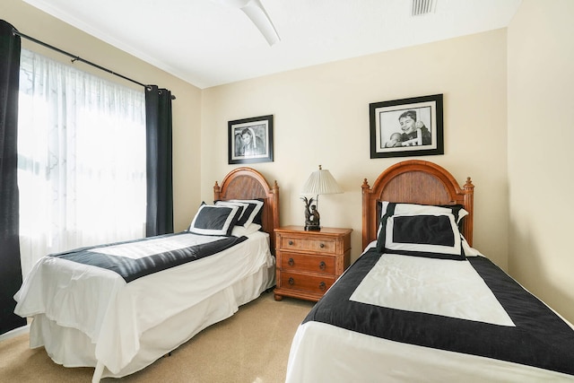 bedroom with visible vents and light colored carpet