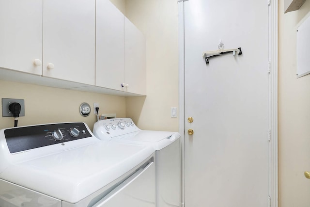 laundry area with cabinet space and independent washer and dryer