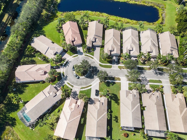 drone / aerial view with a water view and a residential view