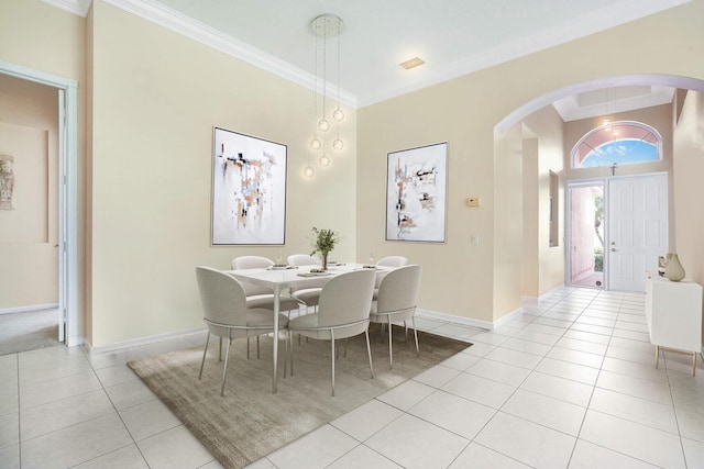 tiled dining space featuring crown molding