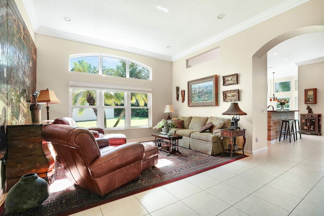 tiled living room featuring ornamental molding and a high ceiling