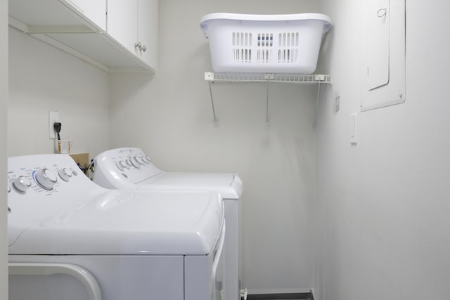 washroom featuring washer and dryer and cabinets