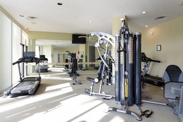 exercise room with a textured ceiling