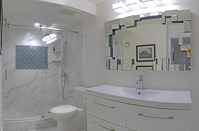 bathroom featuring vanity, toilet, and a shower with shower door