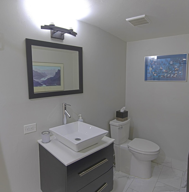 bathroom featuring vanity and toilet