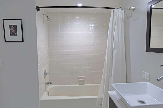 bathroom with shower / tub combo and vanity