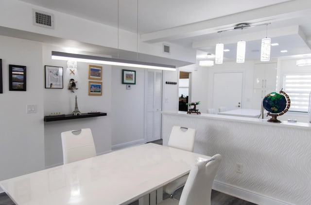 dining space with hardwood / wood-style floors