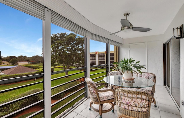 sunroom / solarium featuring ceiling fan