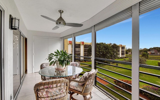 sunroom featuring ceiling fan