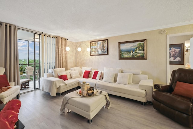 living room featuring hardwood / wood-style floors, expansive windows, ornamental molding, and a textured ceiling