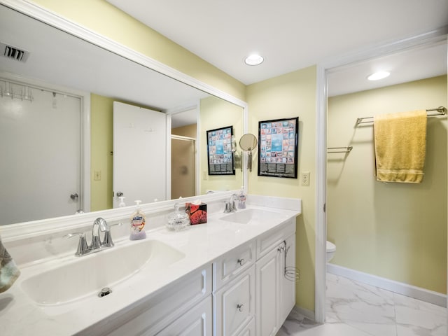 bathroom featuring vanity, toilet, and walk in shower