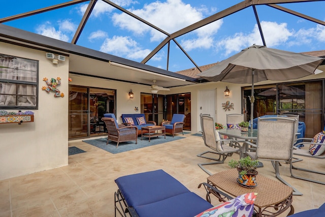 view of patio / terrace featuring an outdoor hangout area, glass enclosure, and ceiling fan