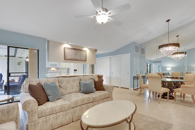 living room with light tile patterned floors, ceiling fan with notable chandelier, and vaulted ceiling