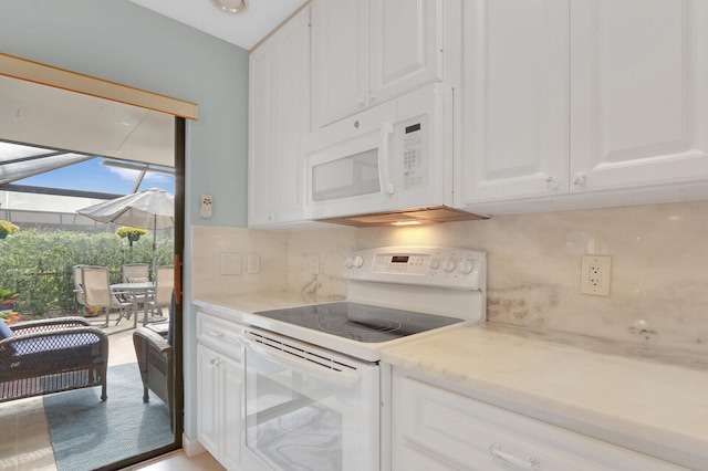 kitchen with decorative backsplash, white cabinetry, and white appliances