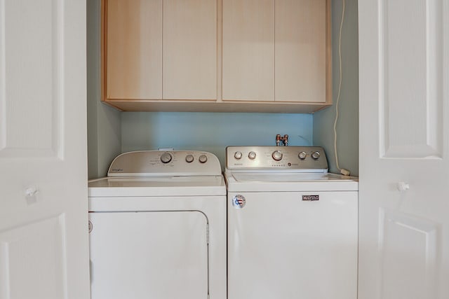 laundry room with cabinets and washer and dryer