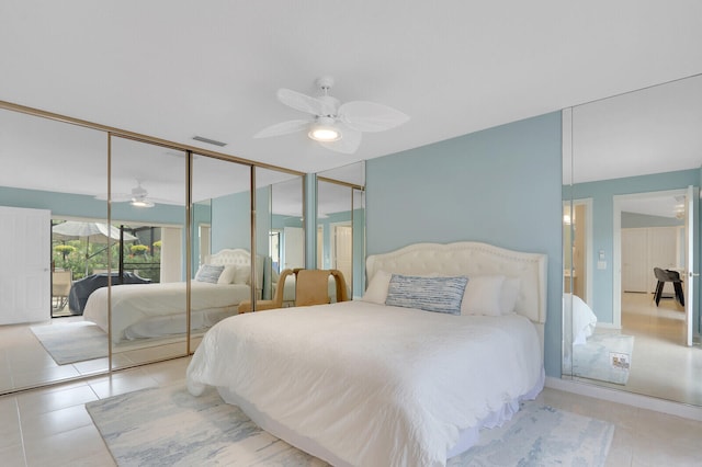 bedroom with ceiling fan, light tile patterned flooring, and a closet