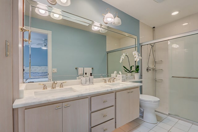 bathroom with tile patterned floors, vanity, toilet, and an enclosed shower